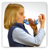 Photo of a young woman using an inhaler for asthma
