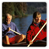 Older couple paddling canoe
