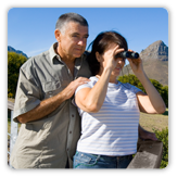 Photo of man with woman looking through binoculars