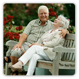 Photo of older married couple sitting on bench