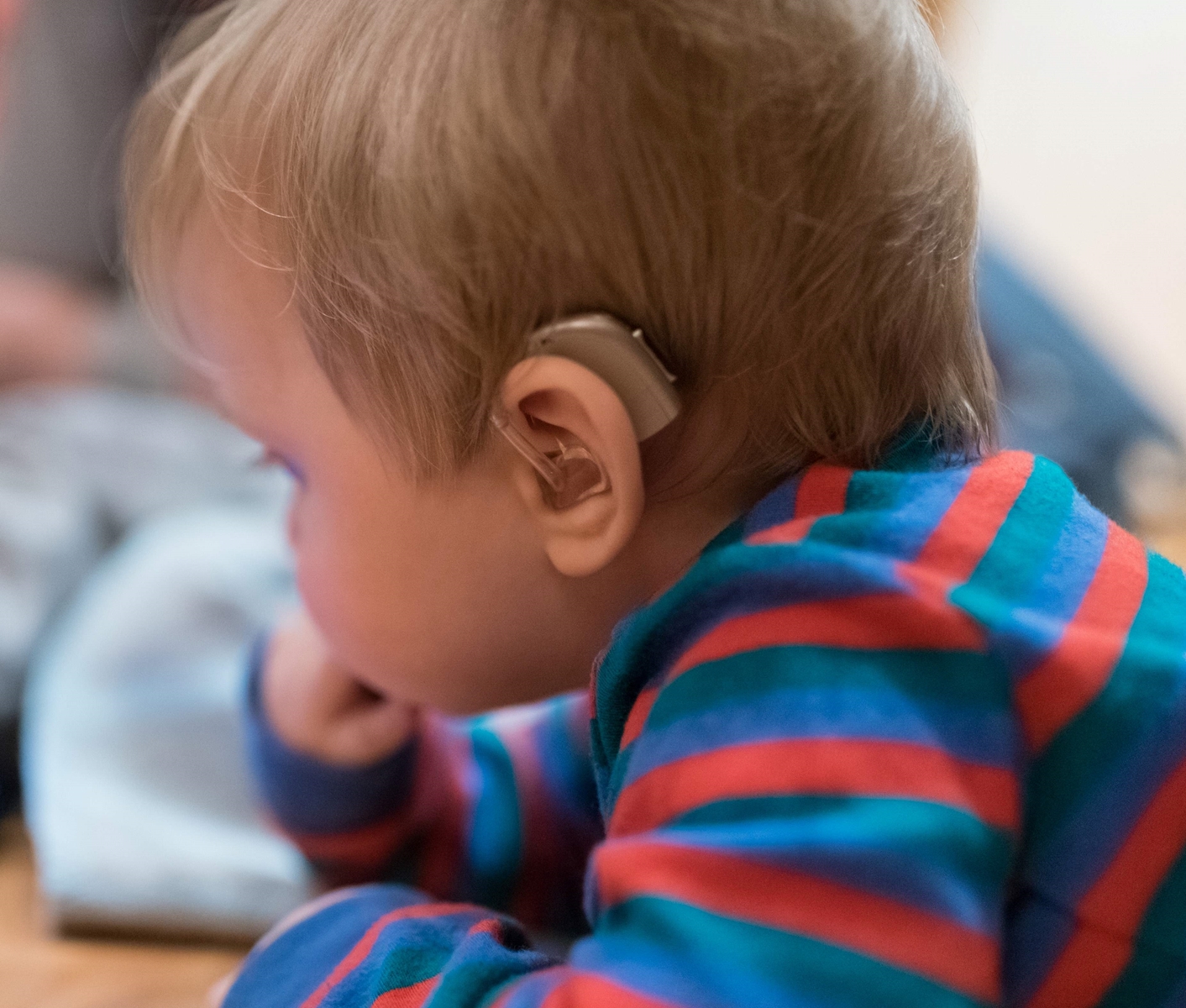 small child with hearing aid