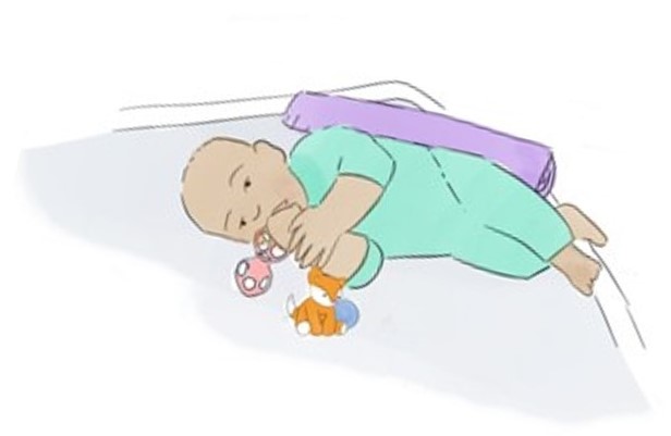 baby lying on side in crib