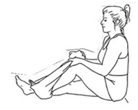 person sitting with back against wall with looped towel around ankle, pulling heel toward buttocks