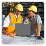 Photo of two men in hard hats on a worksite