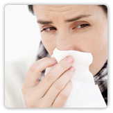 Picture of a woman blowing her nose.