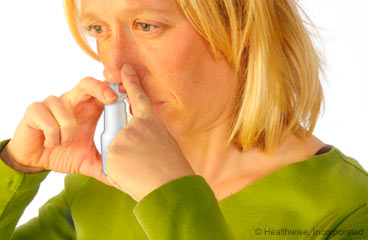 Woman using nasal spray